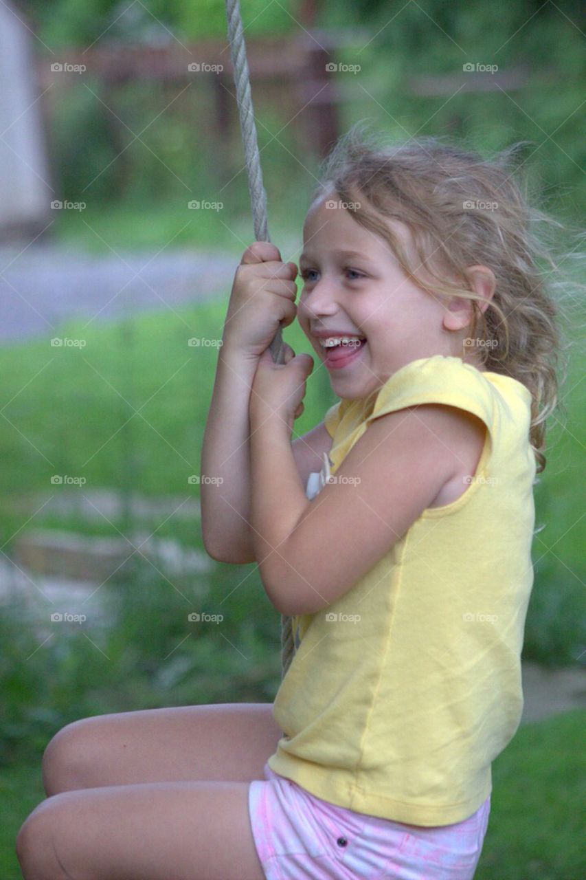 Girl enjoying on rope swing