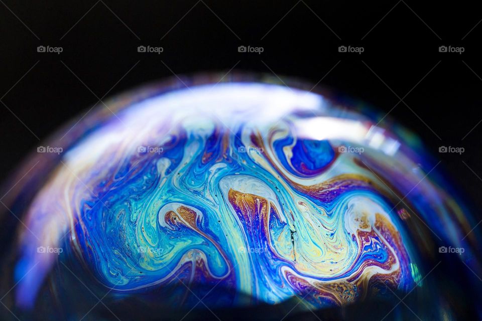 Macro shot of soap bubble, closeup futuristic pattern