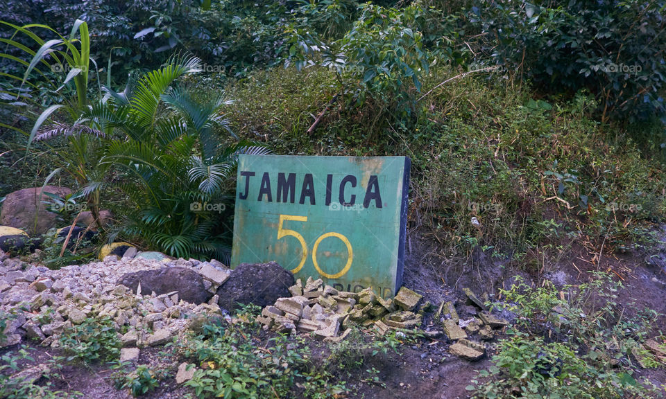Portland Parish, Jamaica - January 1, 2014: Green Jamaica 50 sign by the side of the B1 road in the Blue Mountains region of the Portland Parish, Jamaica on New Years Day morning 2014.