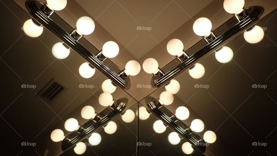 Corner Vanity light bulbs reflecting on mirror
