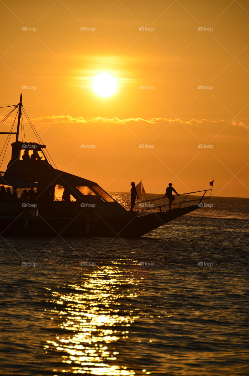 Having fun on the boat during sunset in the Philippines