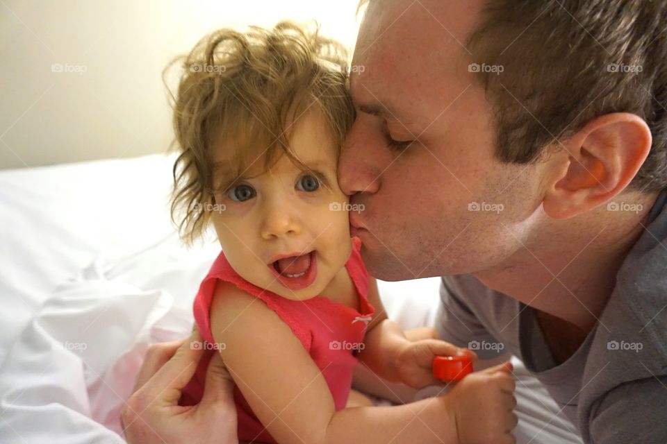 Father kissing baby girl