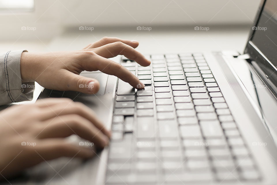 Close-up of child using laptop