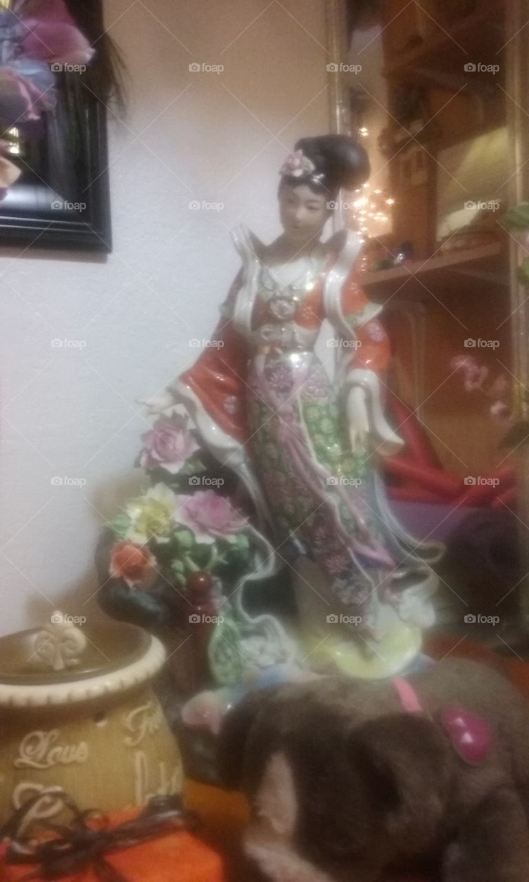 Room decoration, Chinese porcelain doll on a wooden table, artistic display.