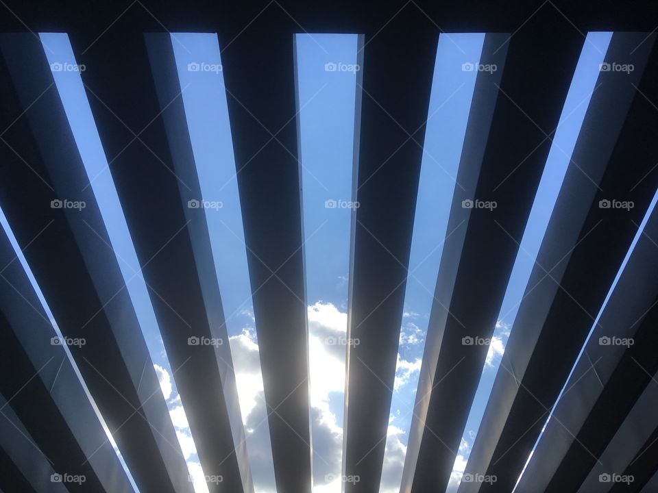 View up through the wooden slats of the Virginia Water Lake Visitor Centre, Virginia Water. Blue sky with some cloud visible. Visited in Summer.