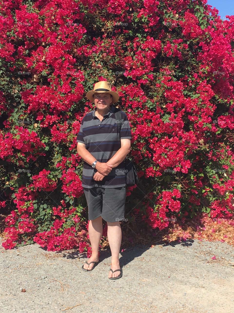 Pic of a friend next to a lovely red Shrubs in Cyprus