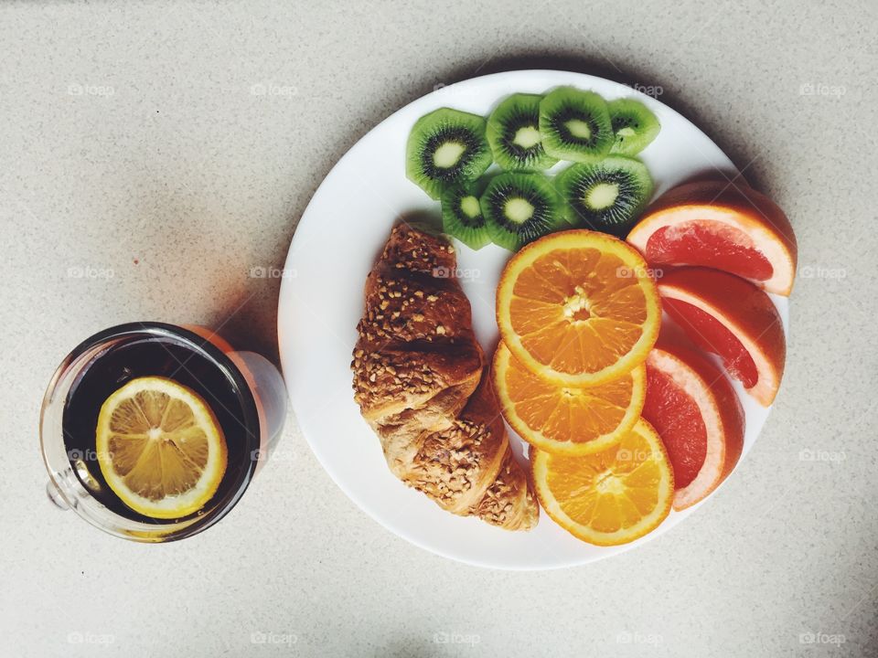 High angle view of croissant with grapefruit