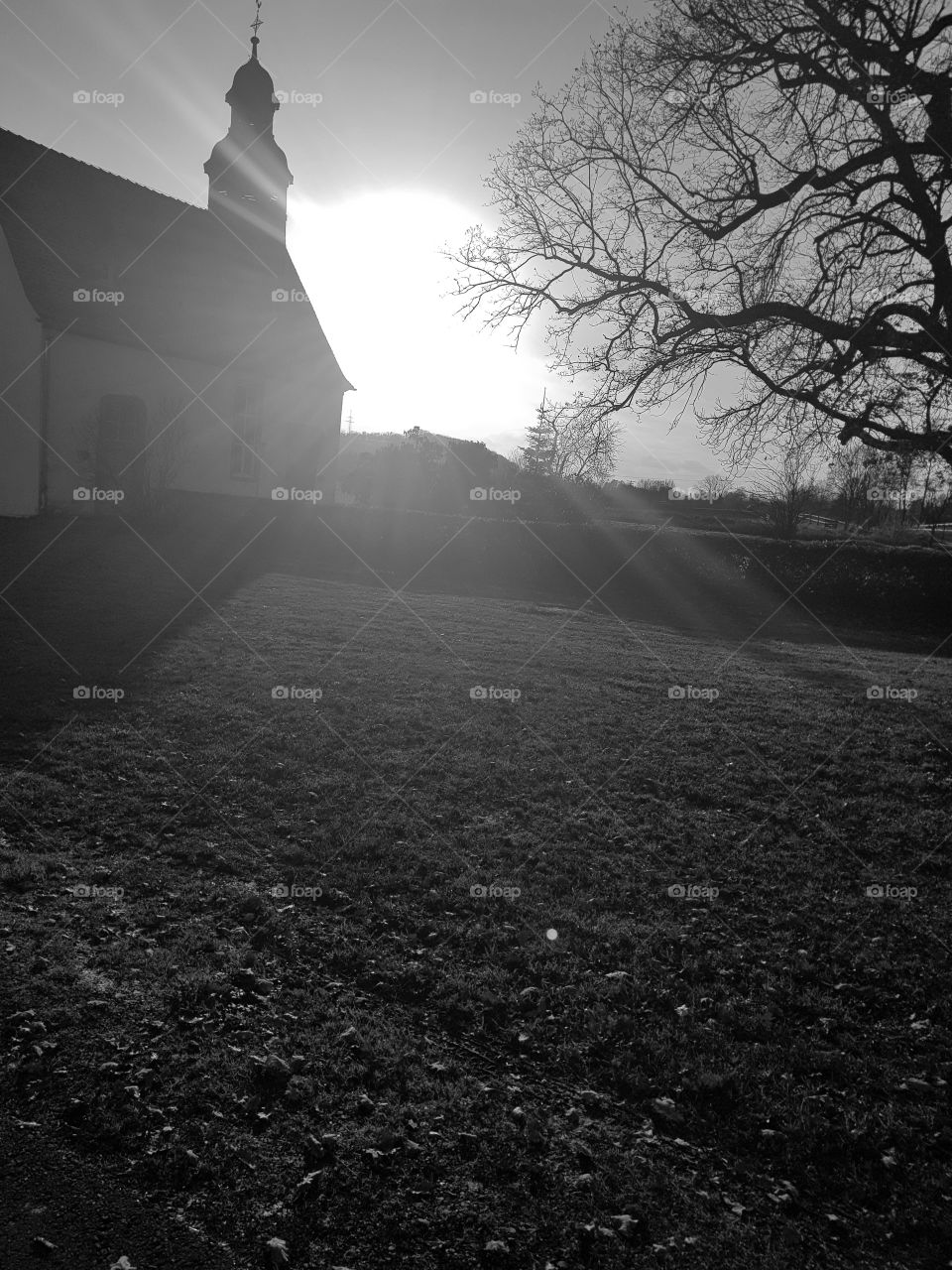 sundown behind a church black and white