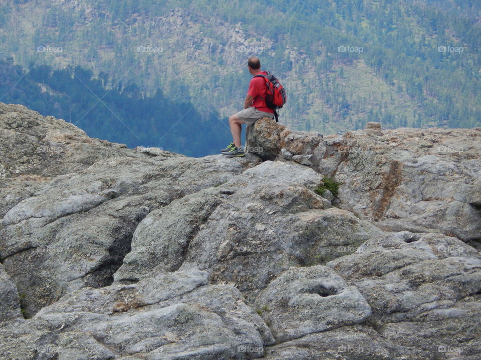 Hiker resting at the top of the mountain