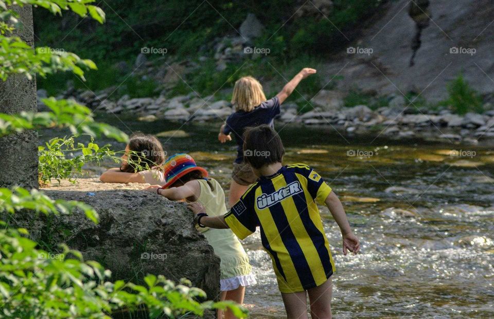 Kids play in river