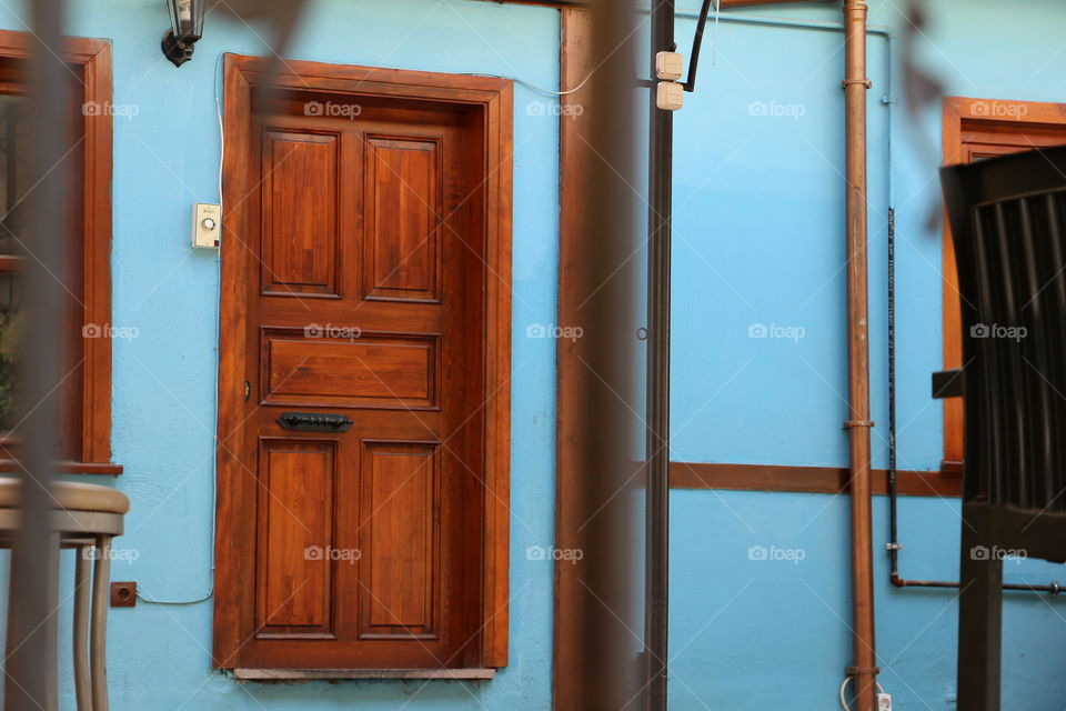 Wood door blue wall