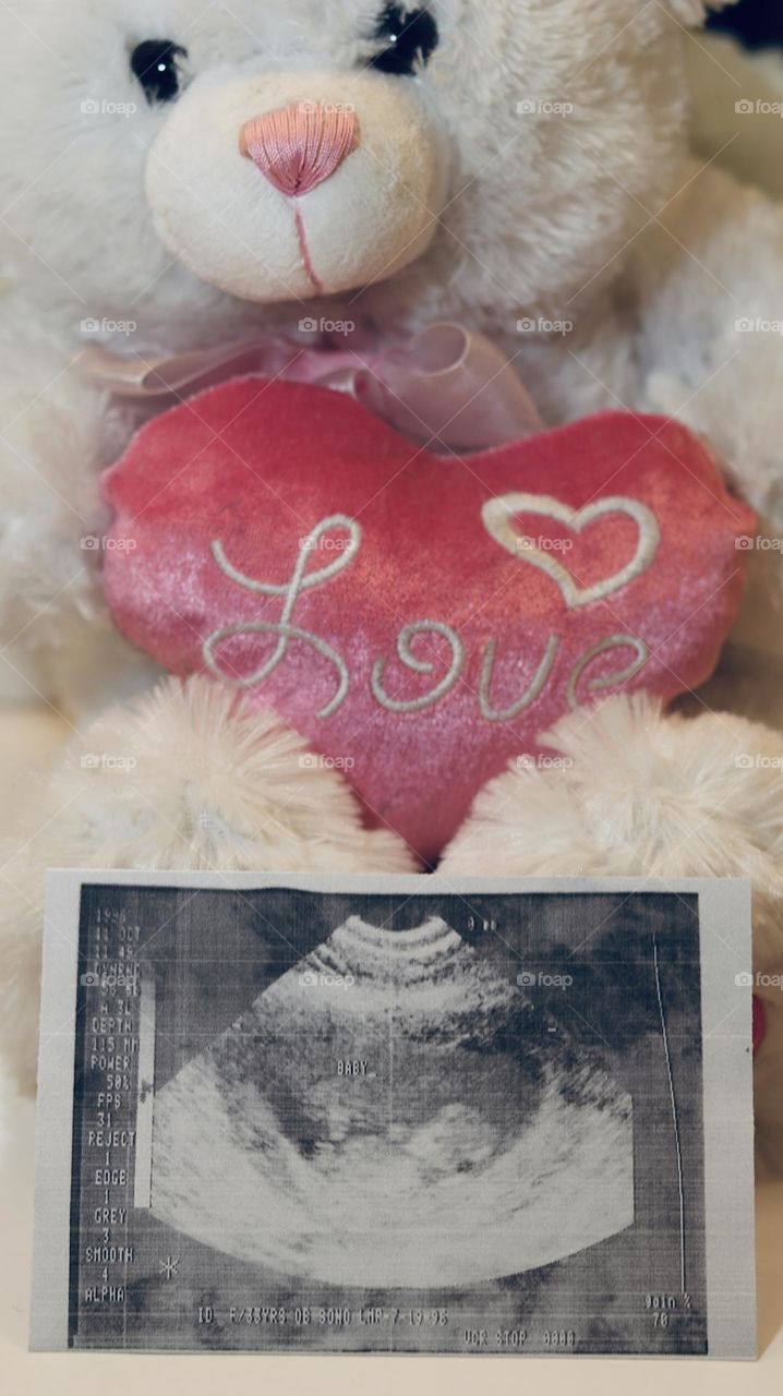 First photo of a new human expected with love next to first teddy bear