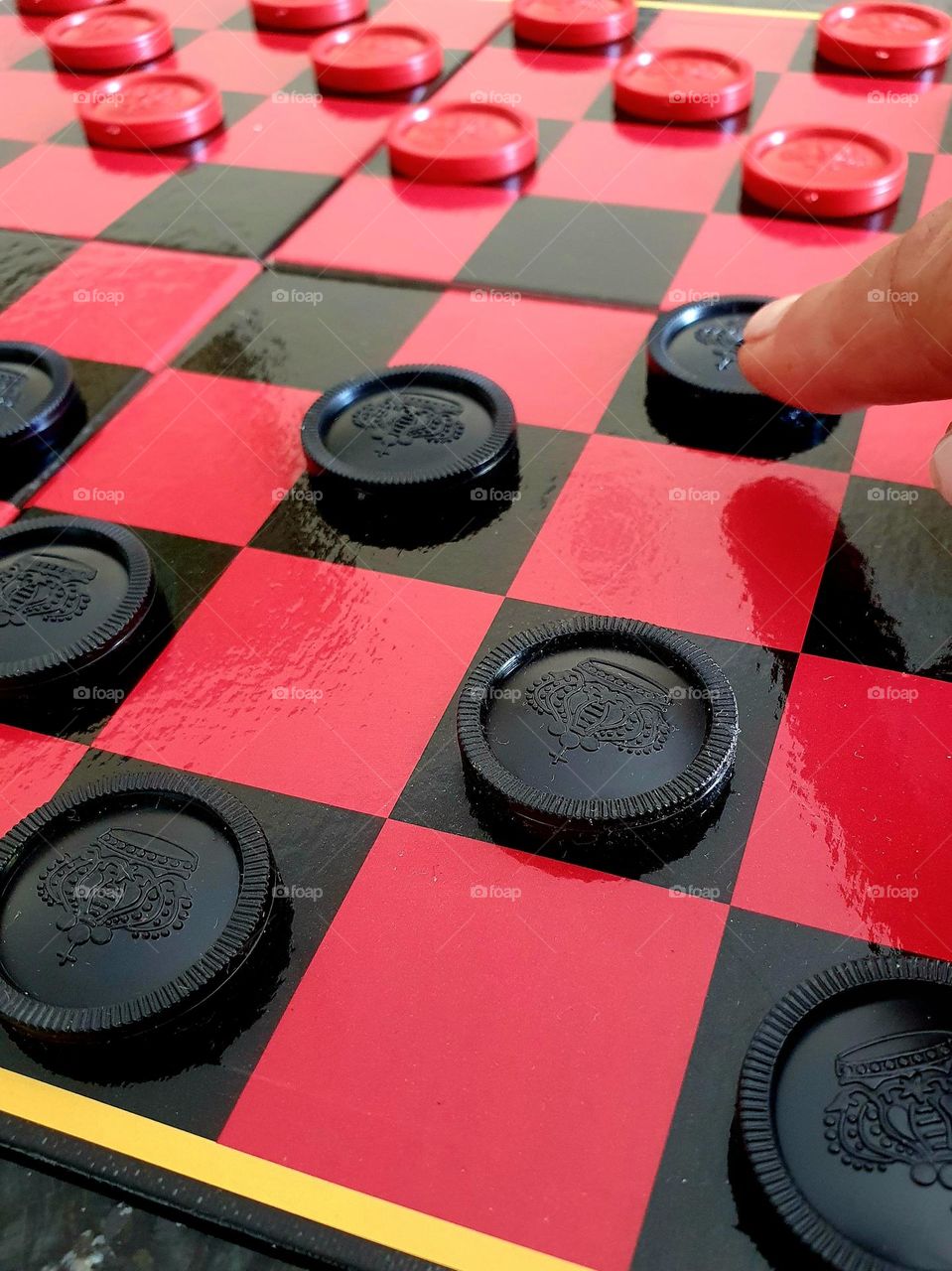 circles- checkers game in the colours black and red with round game pieces