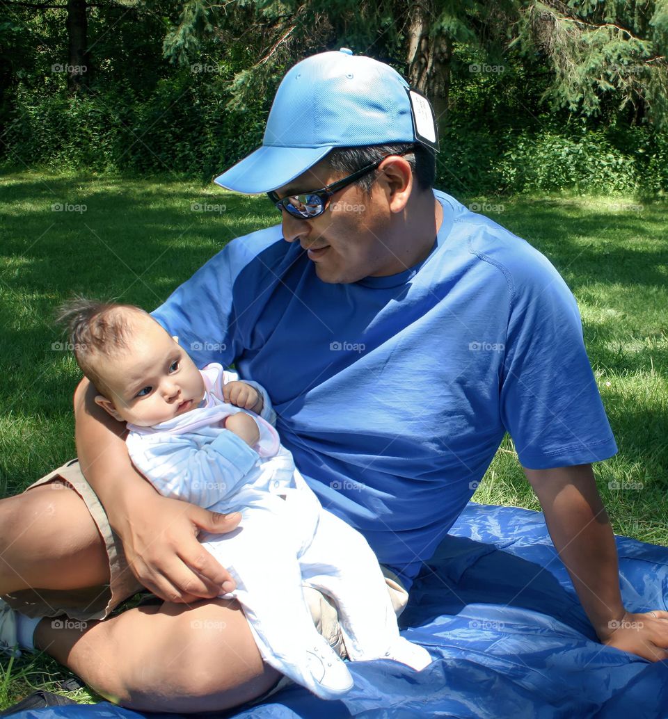 Happy father with his cute baby outdoors