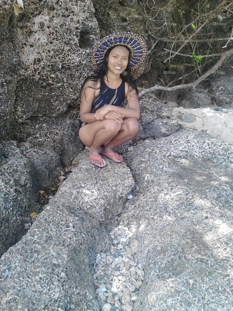 wearing a native hat on the beach