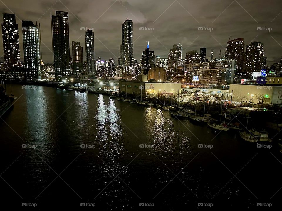 This is “Newtown Creek” at night seen from the “Pulaski Bridge” that connects “Greenpoint”, Brooklyn to LIC, Queens. In the distance we can see “Manhattan” including the “Empire State Building”. 2013. Hypnotic Productions
