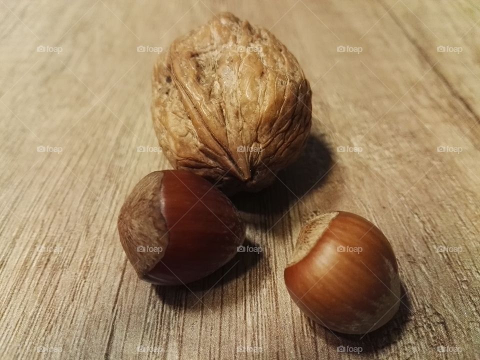 walnut and hazelnuts on wooden table