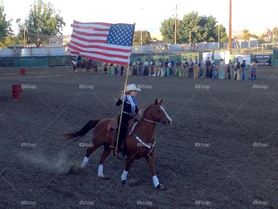Me (Miss Salinas Valley Fair) carrying the flag horseback for the national anthem! 