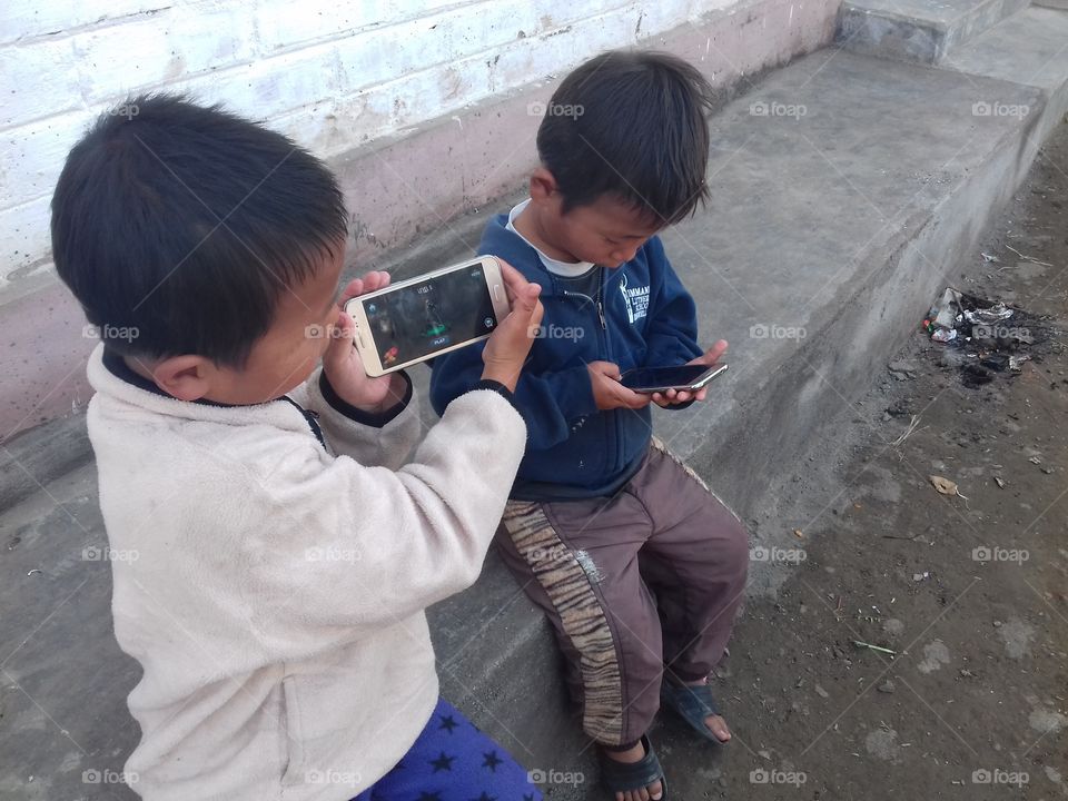 children ejoying mobile games