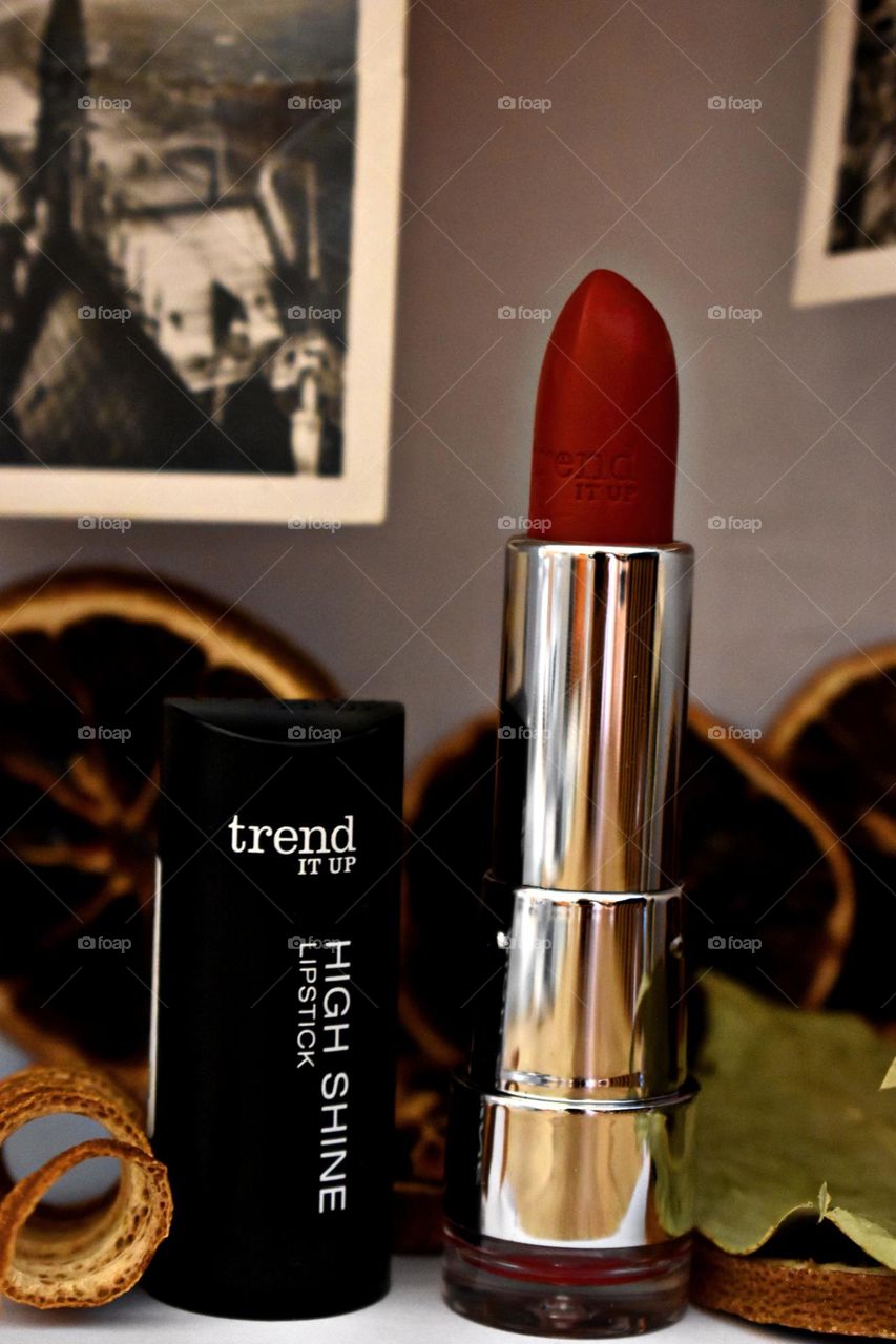 Red lipstick with old pictures in the background.
