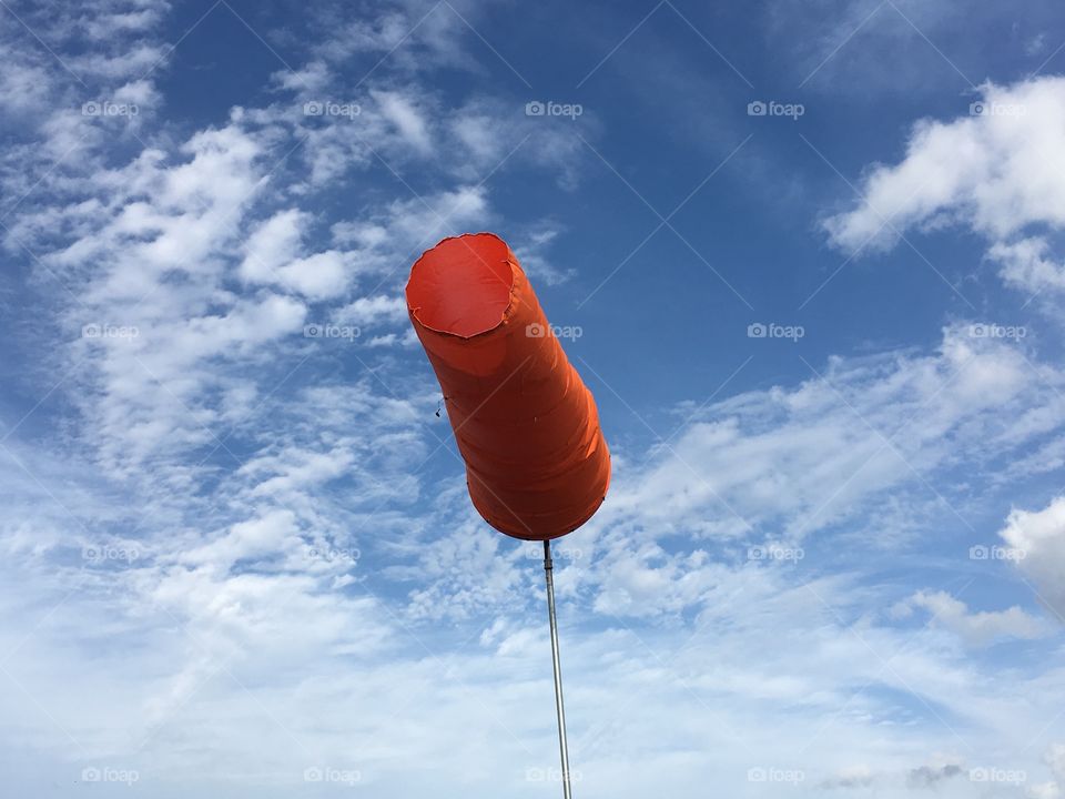 Orange windsock blowing in the wind 