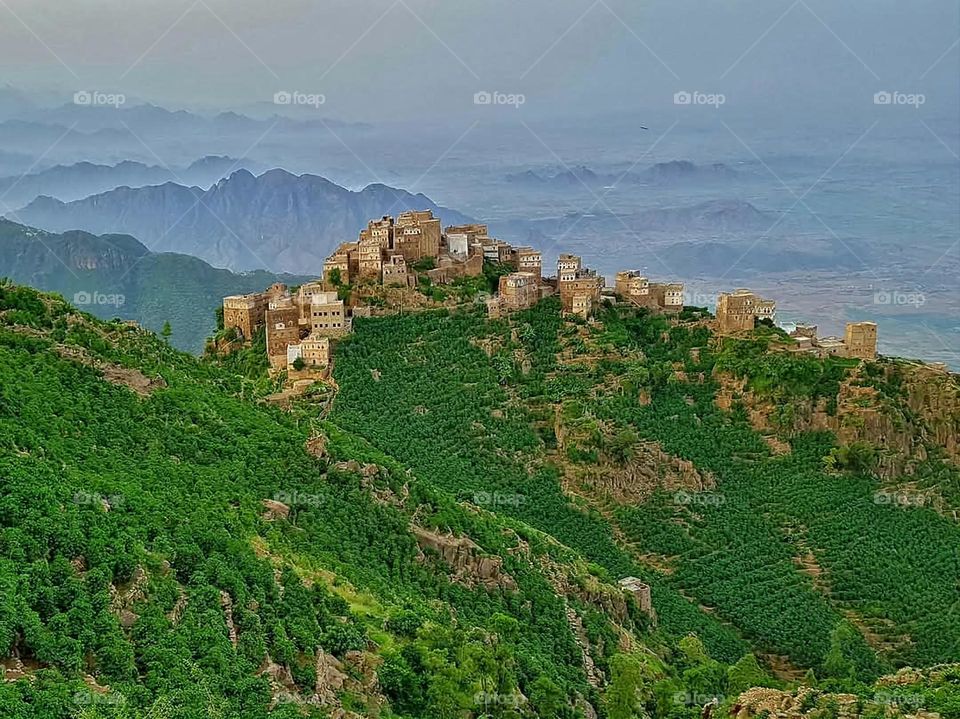A stunning view of green mountains covered in fog in Yemen