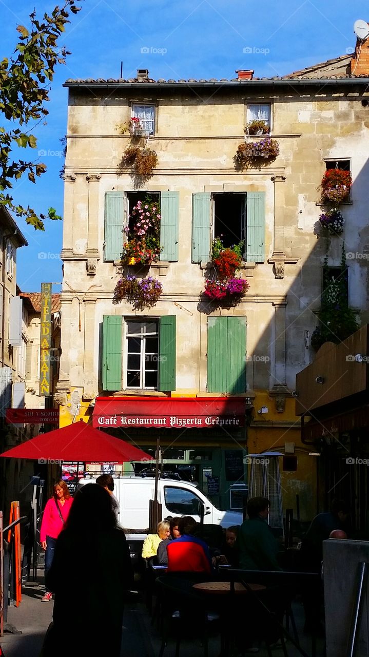 window flowers. window flowers hanging from an old house in Arles.