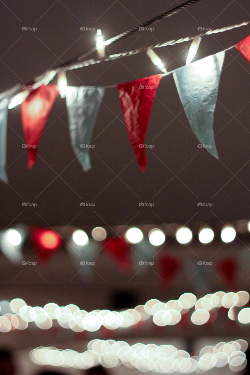 Bunting and fairy lights adorn the ceiling of a reception 