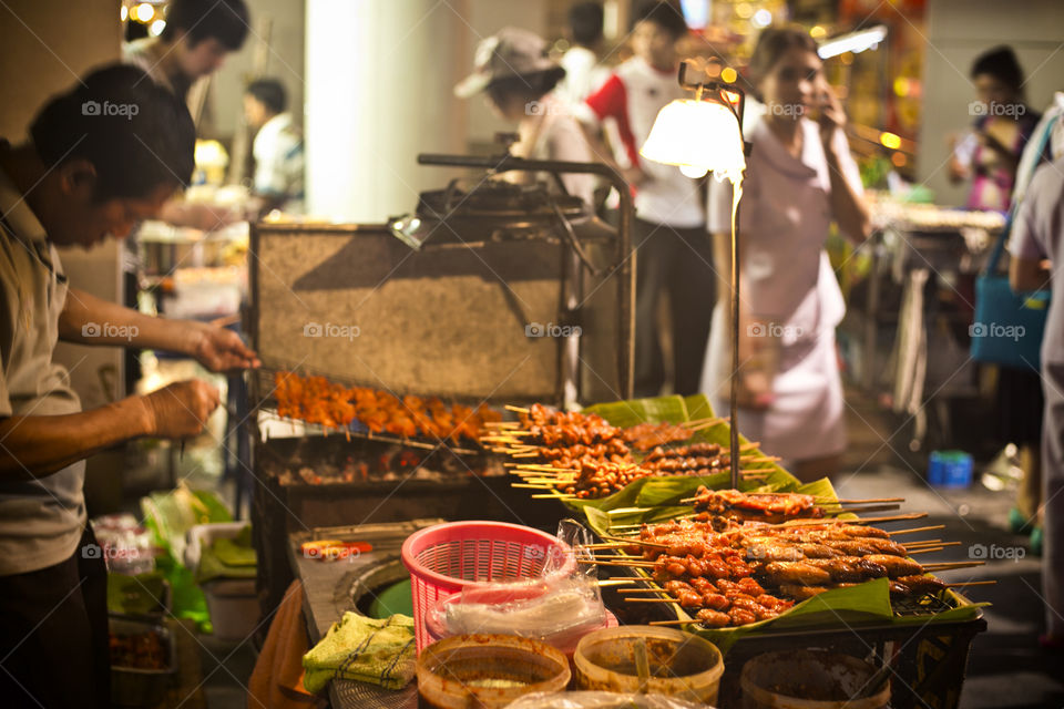 Streets vendor in Bangkok. selection of meat skewers for snack