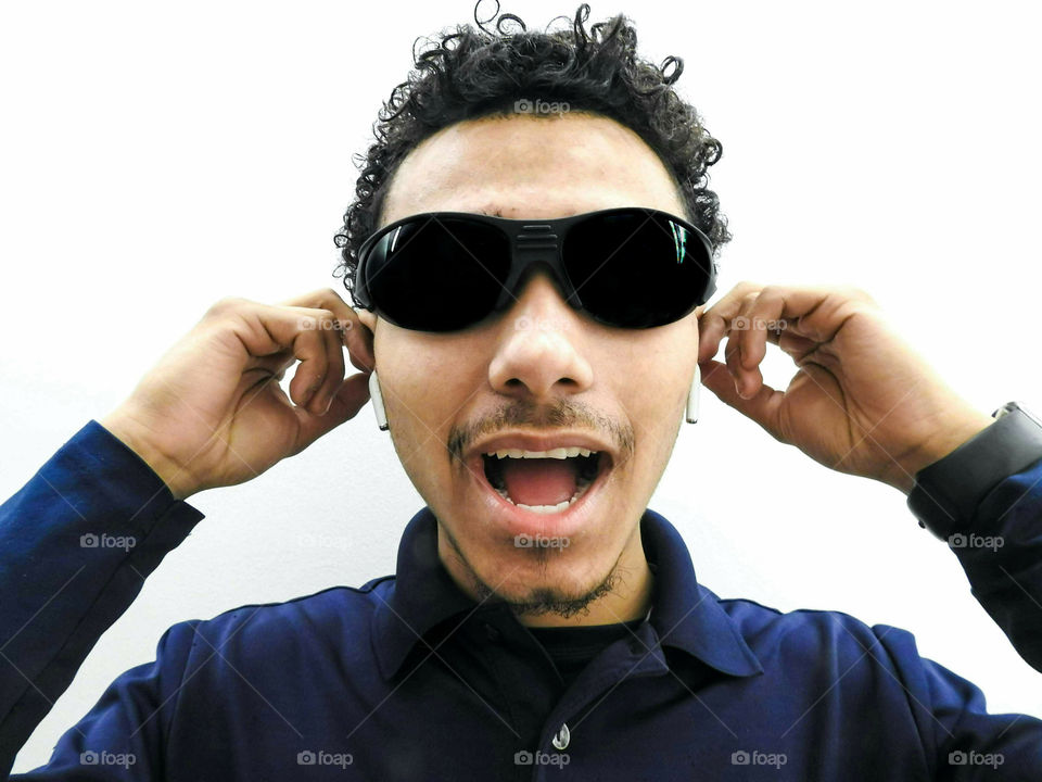 Young Guy Listening To Music With Ear Buds