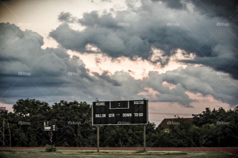 Clouds before sunset over the football field 