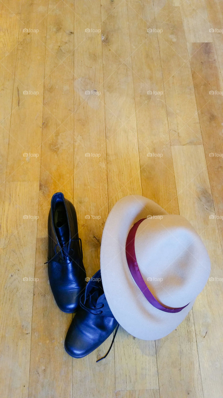 Hat and shoes on wooden floor