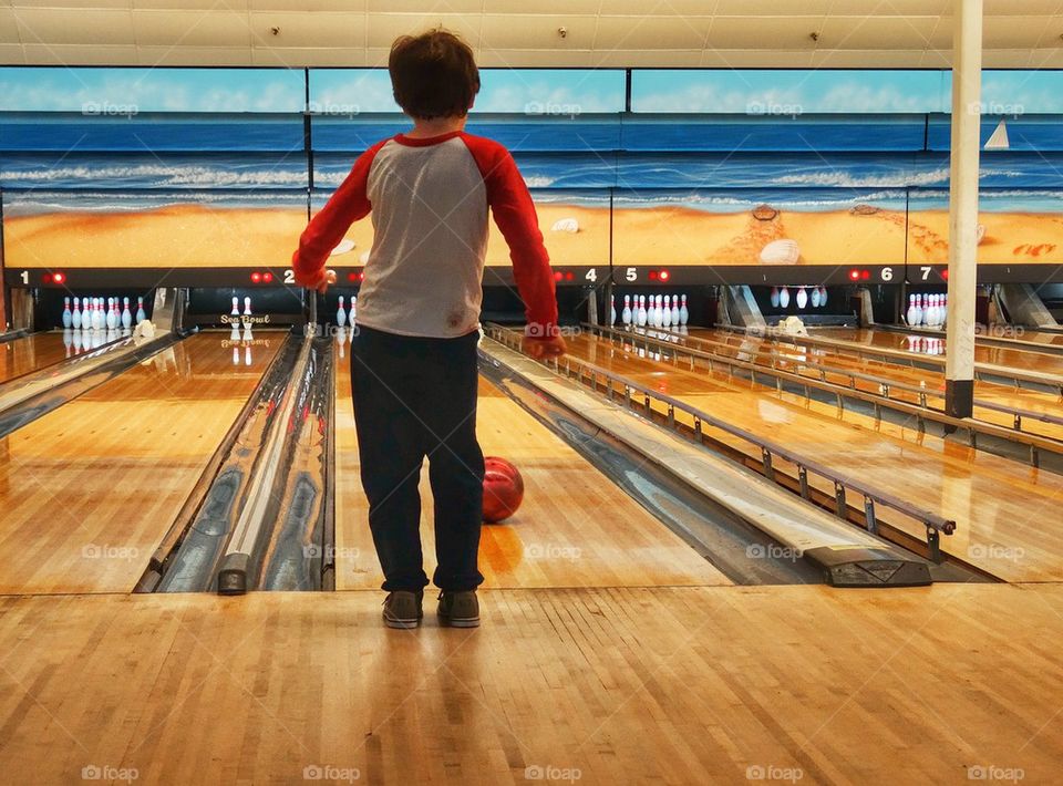 Young Boy At The Bowling Alley. American Pastime