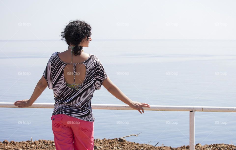 A woman looking at the sea view