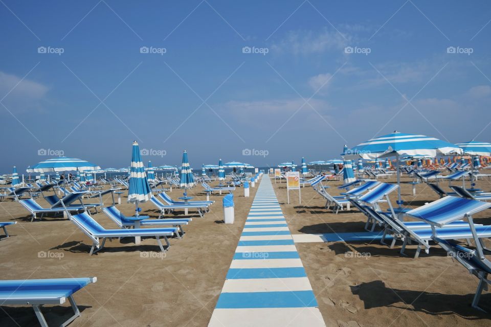 Sunloungers and parasols on a sandy beach