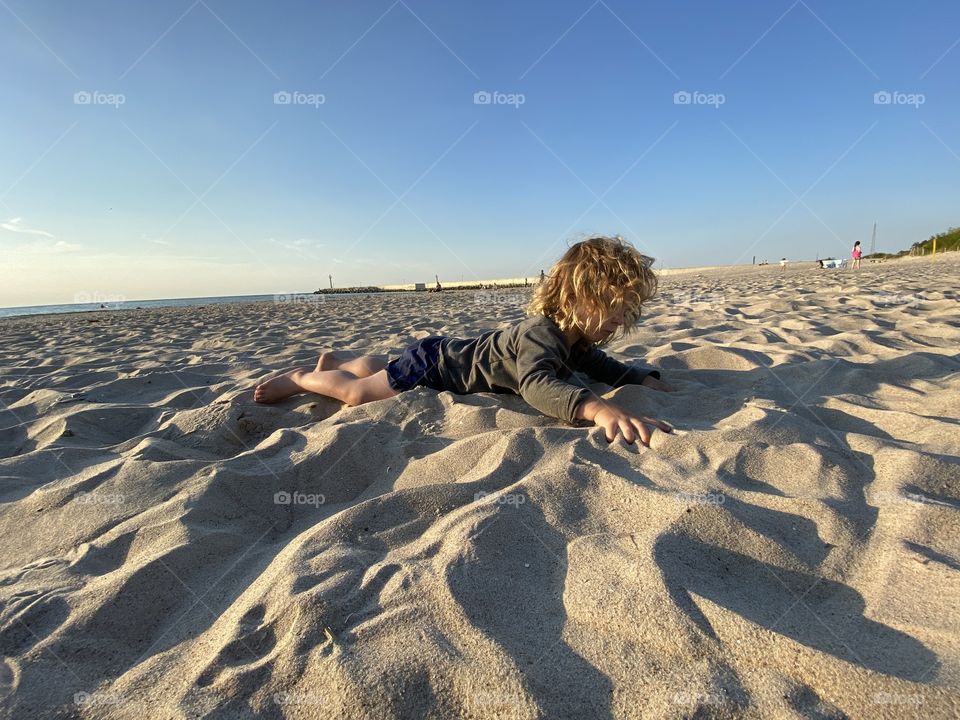 Boy playing on the beach 
