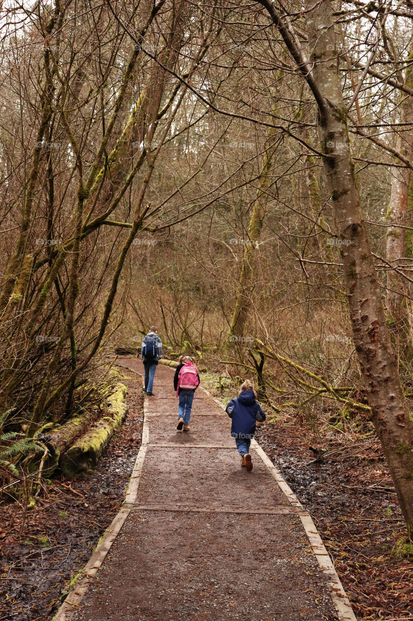 Siblings hiking through a forest