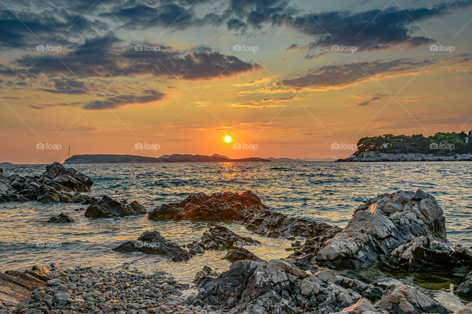 Sunset over rocky beach