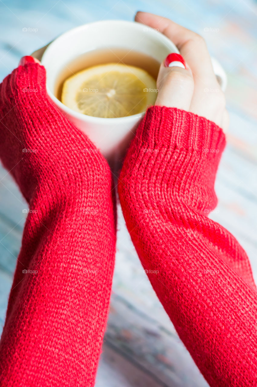 Woman hand with cup of tea