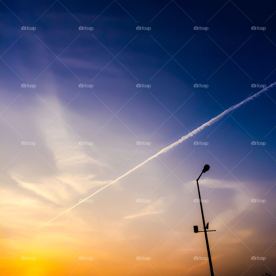 Silhouette of street light at sunset