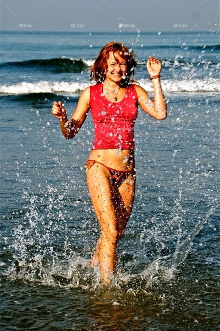 Water splash and smiling girl