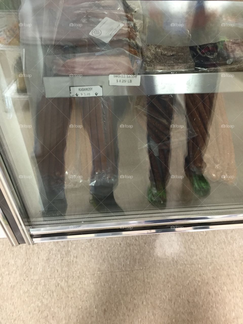 2 Men. Picture taken of two men from the waist down through display glass.
