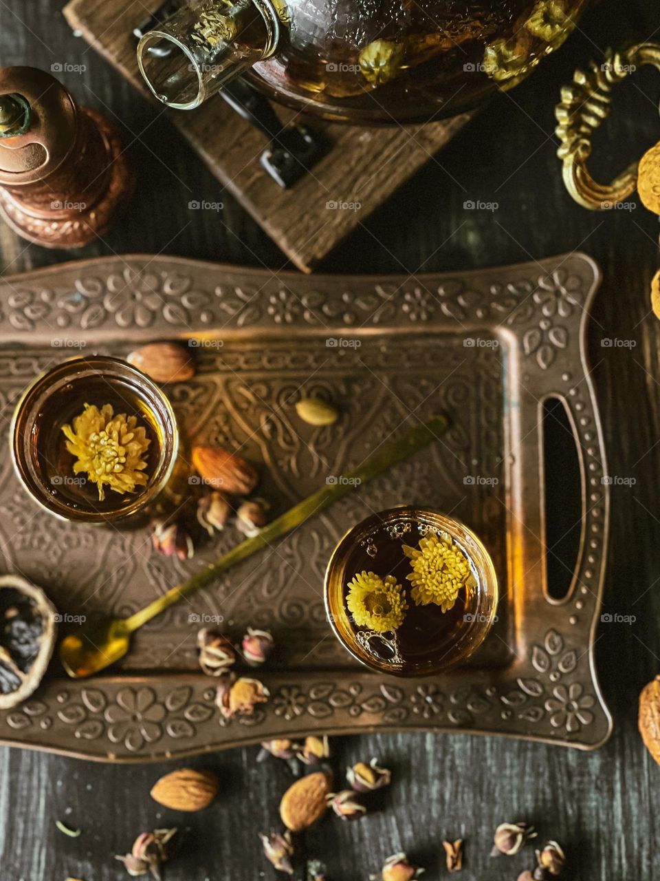 Cups of flower tea on a copper tray and view from top