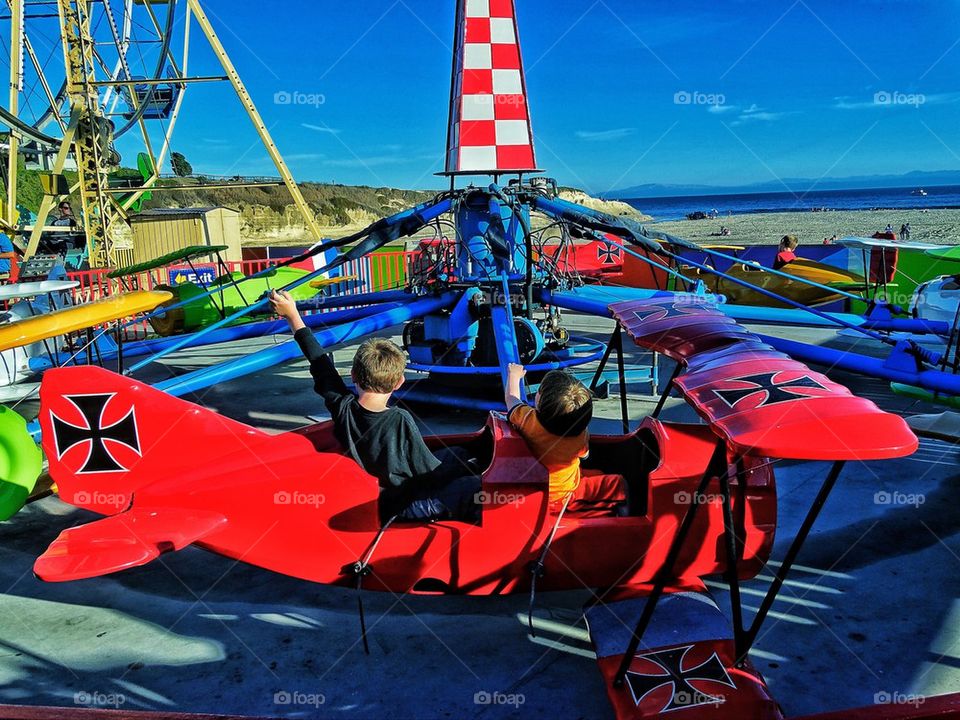 Brothers on an amusement park ride