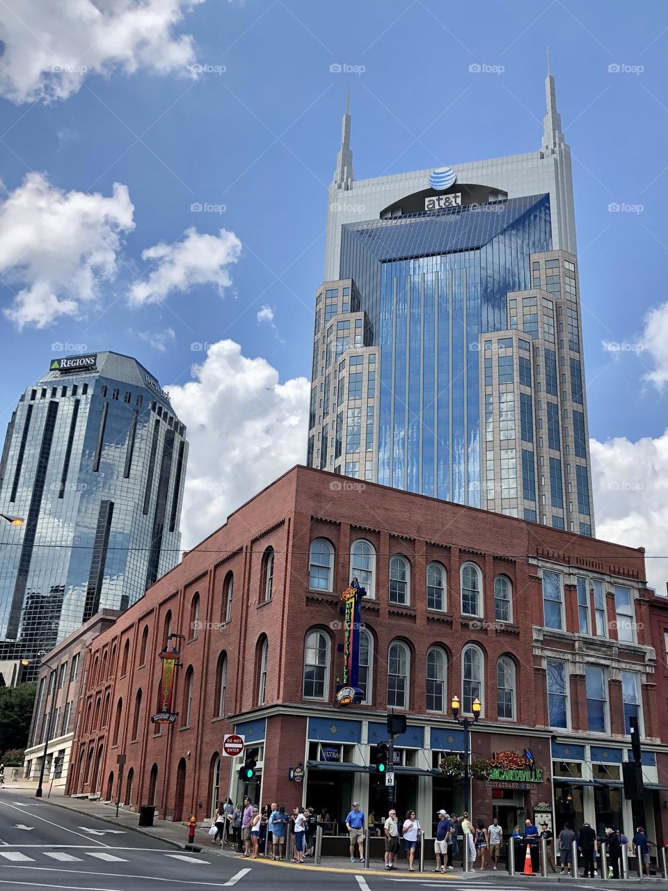 Batman building in downtown Nashville on summer day corner tourists