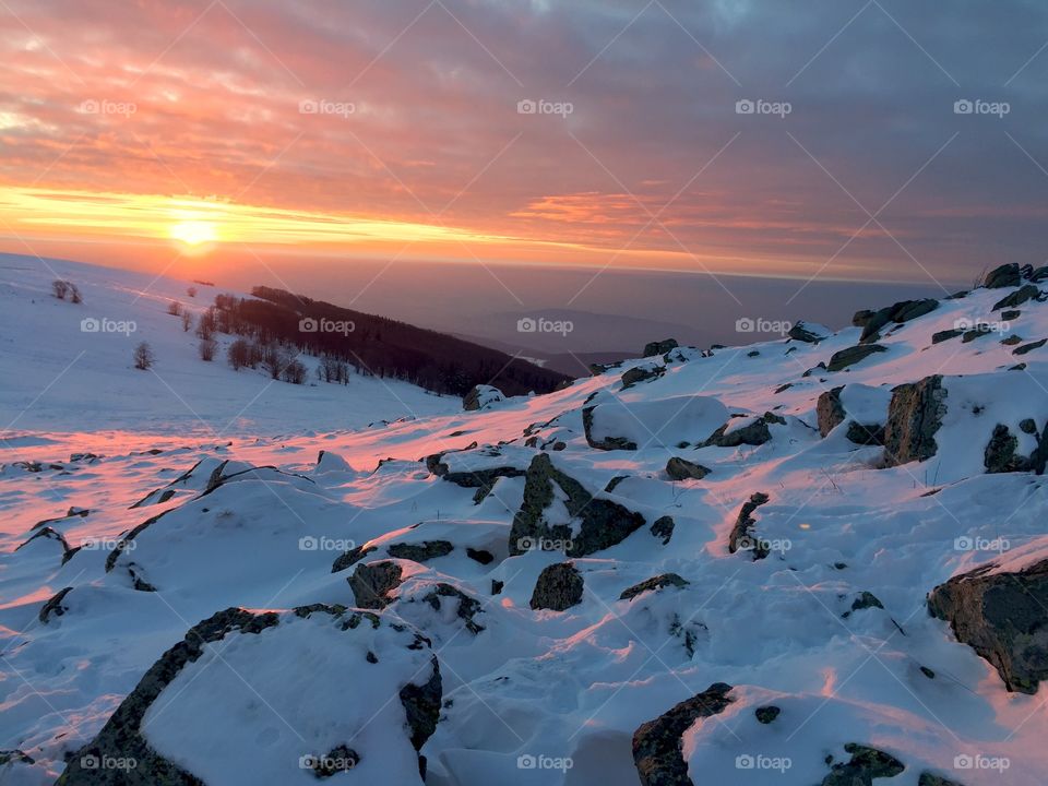 Scenic view of snow and sunset