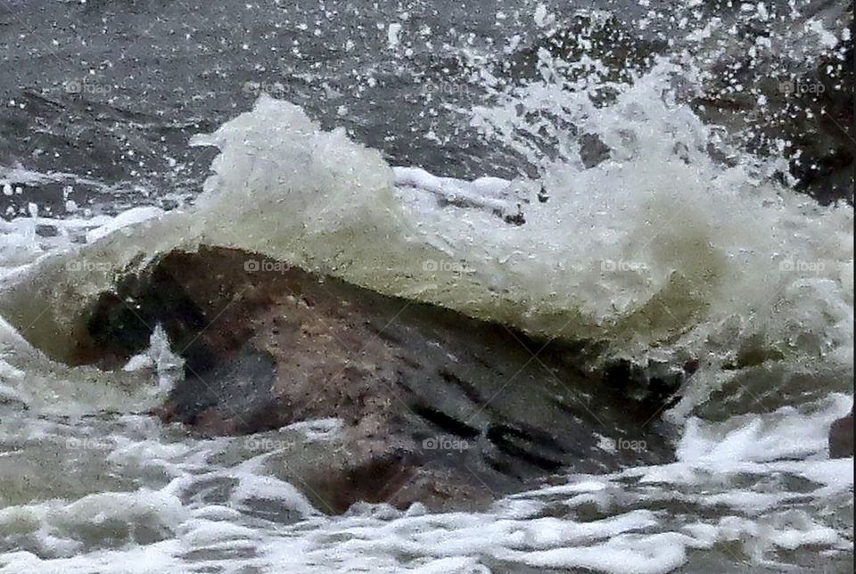 Waves breaking over a rock