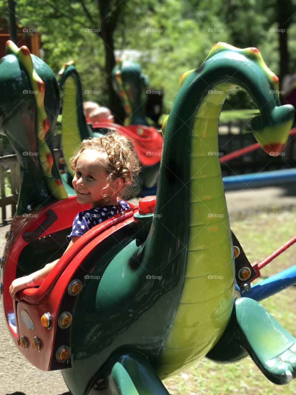 Little girl enjoying ride in amusement park