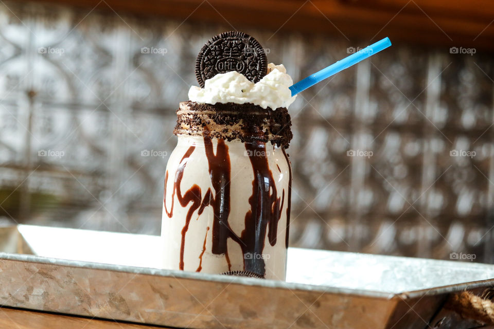 Cookies and cream milkshake with chocolate drizzle.