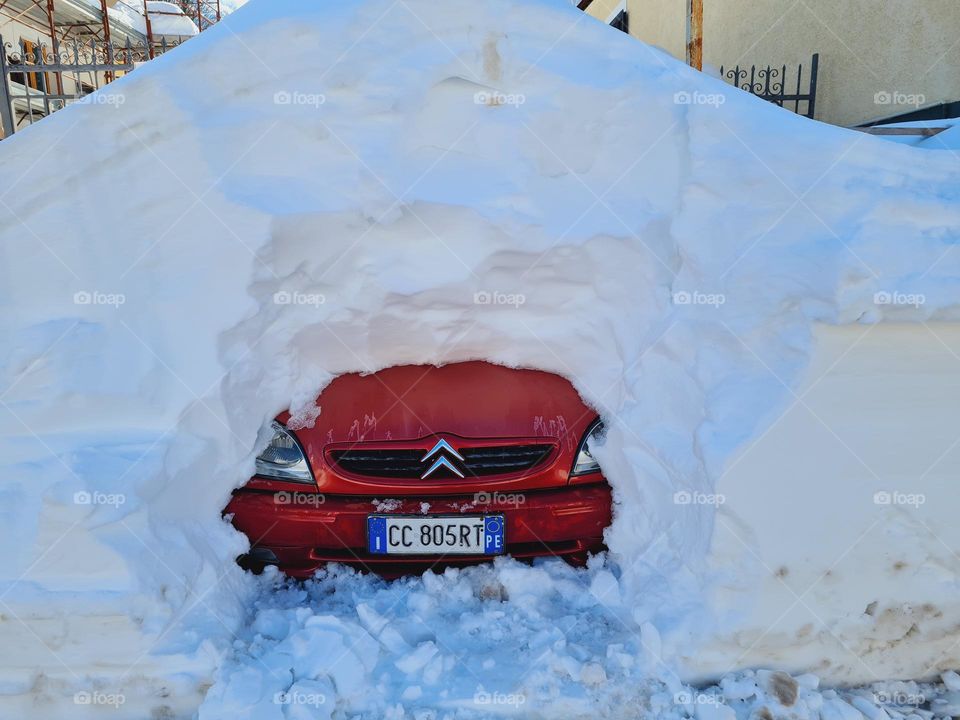 car covered with a pile of snow